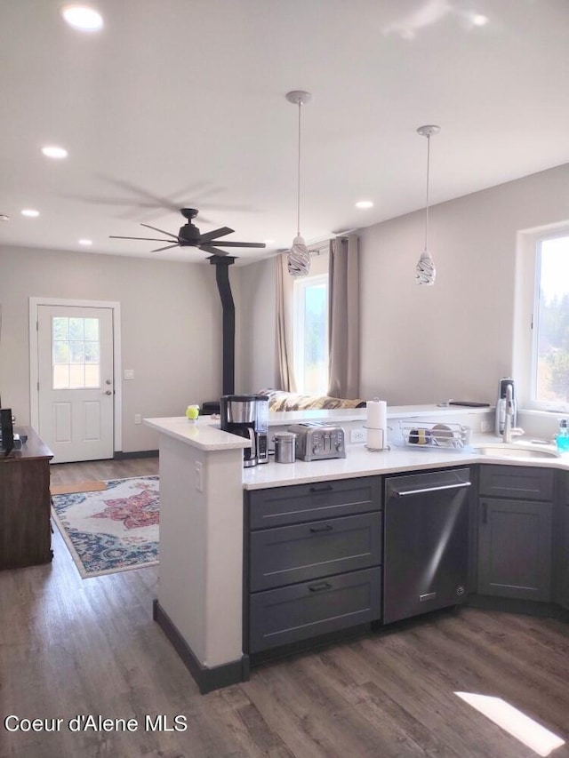 kitchen featuring hanging light fixtures, dishwasher, dark wood-type flooring, and a wealth of natural light