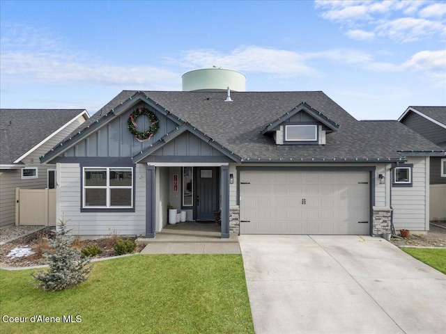 view of front of property featuring a garage and a front yard