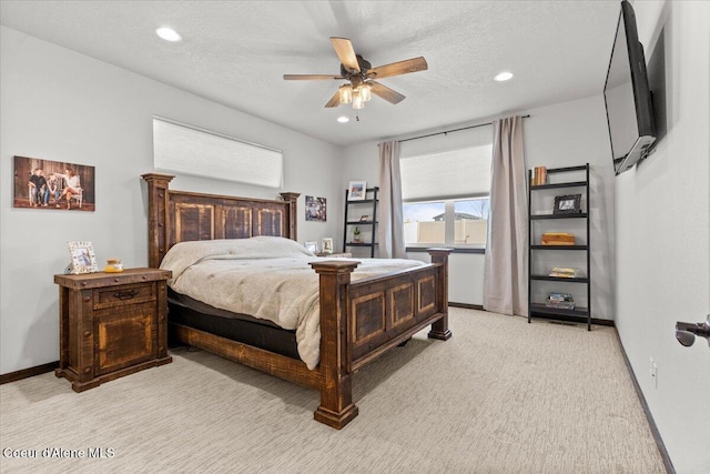 bedroom with light carpet, ceiling fan, and a textured ceiling