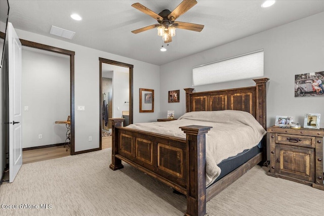 carpeted bedroom with connected bathroom and ceiling fan