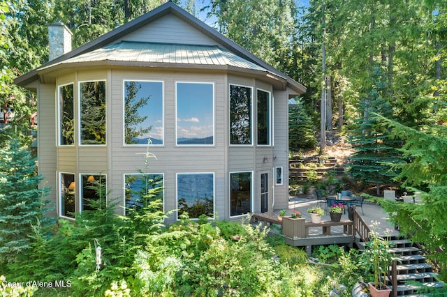 rear view of property featuring a wooden deck