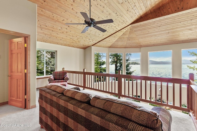 sunroom featuring a water view, lofted ceiling, and wood ceiling