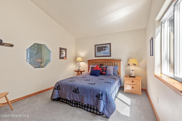 carpeted bedroom with multiple windows and vaulted ceiling