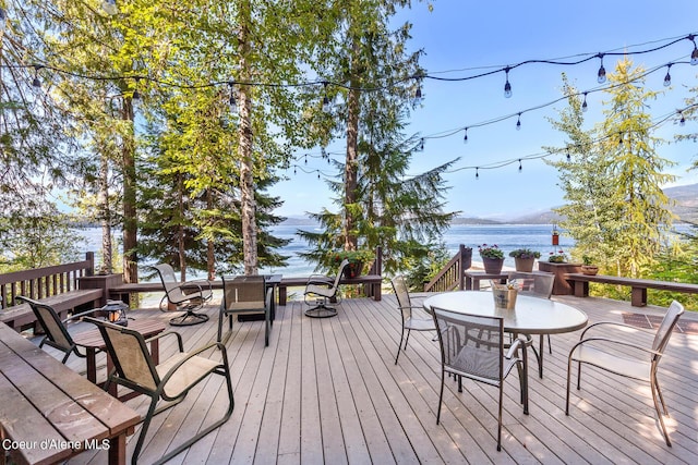 wooden terrace with a water and mountain view