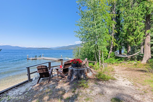 view of dock featuring a water and mountain view