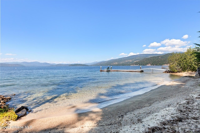 view of water feature with a mountain view and a boat dock