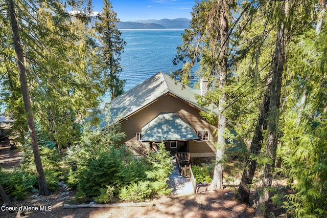 view of front of property featuring a water and mountain view