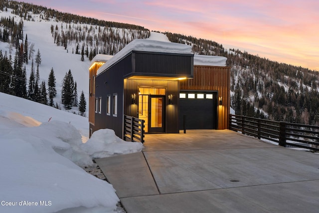 modern home with a garage and a mountain view