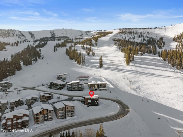 snowy aerial view featuring a mountain view