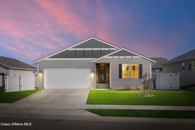 view of front of home featuring a yard and a garage