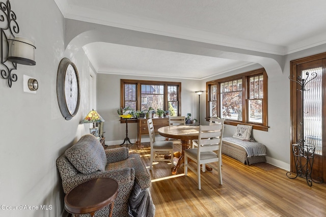 dining area featuring crown molding and wood-type flooring