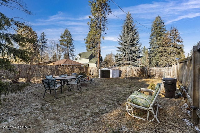 view of yard with a storage shed and a patio area