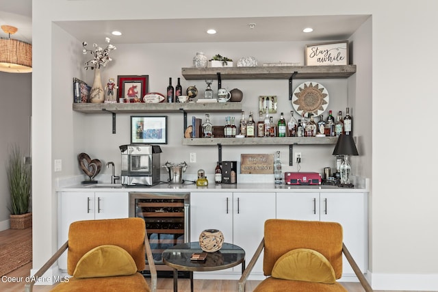 bar with wine cooler, sink, and wood-type flooring