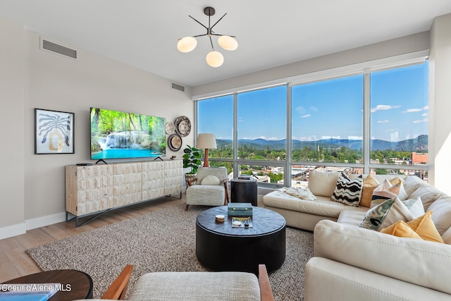 living room with wood-type flooring and a chandelier