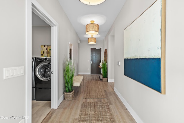 hallway featuring washer / clothes dryer and light wood-type flooring