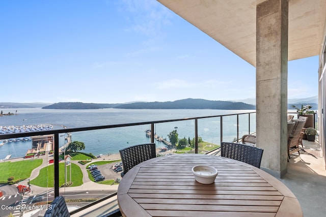 balcony featuring a water and mountain view