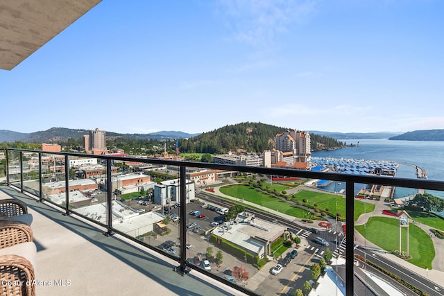 balcony featuring a water and mountain view