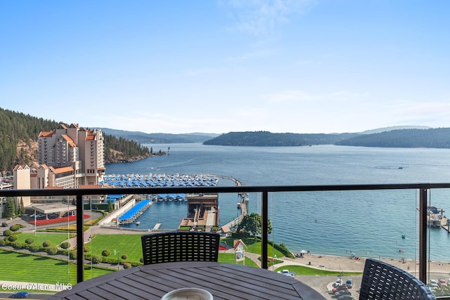 balcony featuring a water and mountain view