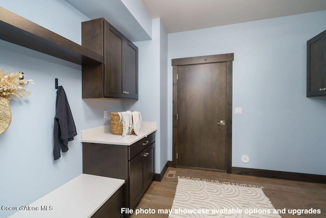 interior space with dark brown cabinets and dark hardwood / wood-style floors