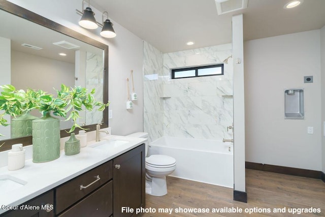 full bathroom with vanity, toilet, tiled shower / bath combo, and wood-type flooring