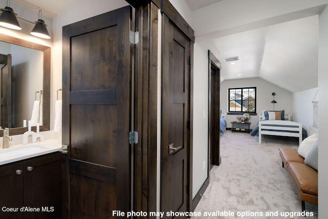 bathroom with vanity and vaulted ceiling