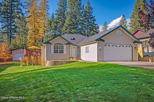 ranch-style house featuring a garage and a front lawn