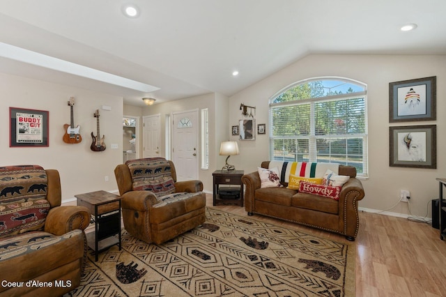 living room featuring lofted ceiling and light wood-type flooring