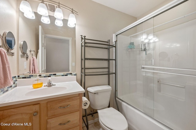 full bathroom featuring enclosed tub / shower combo, vanity, and toilet