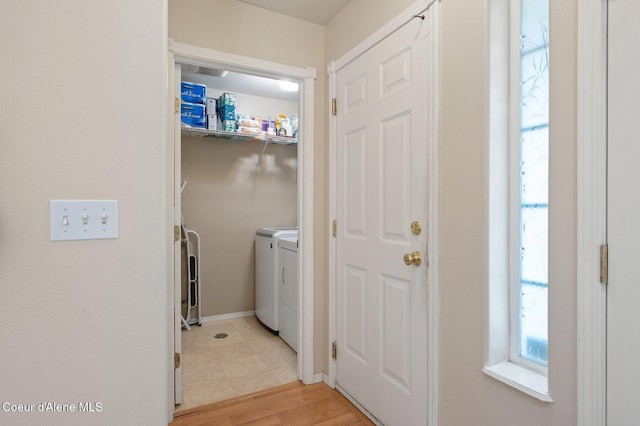 laundry area featuring washer and dryer and light wood-type flooring