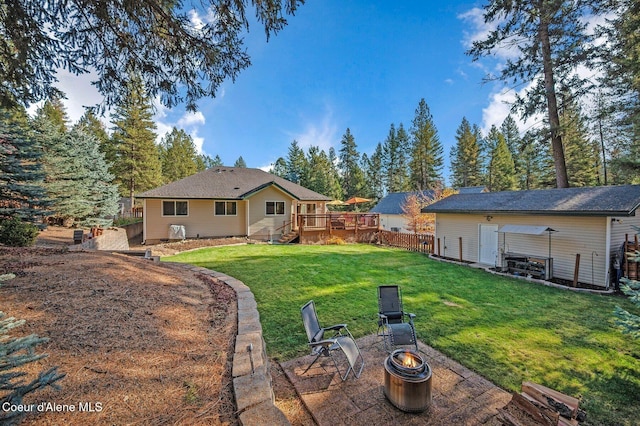 view of yard with a wooden deck and an outdoor fire pit