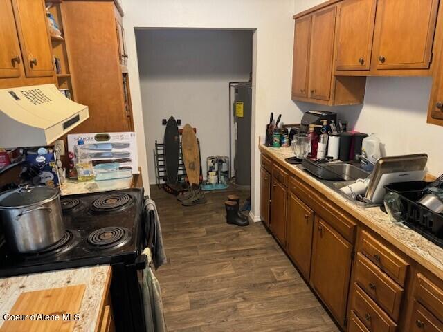 kitchen featuring sink, electric water heater, dark hardwood / wood-style flooring, black range with electric cooktop, and exhaust hood