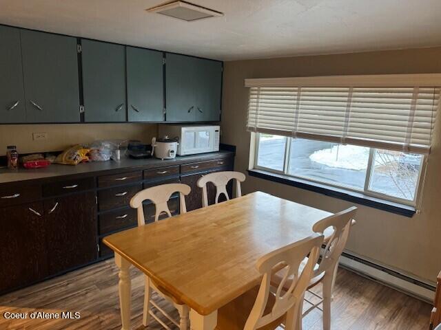 dining area featuring hardwood / wood-style flooring and a baseboard radiator