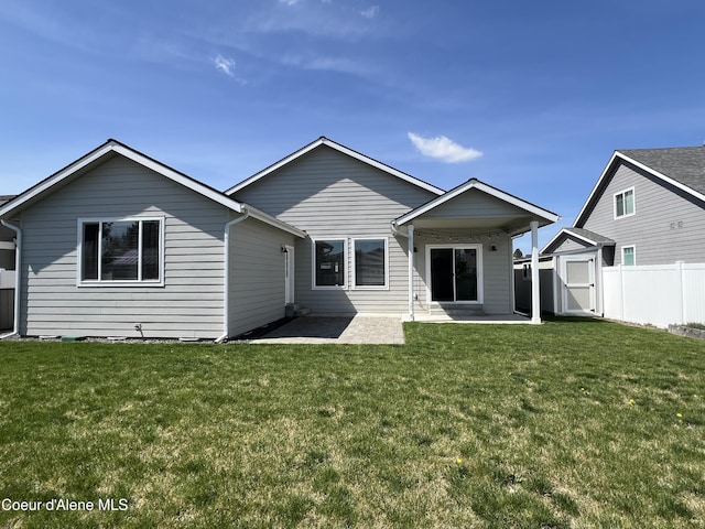 9256 Gettys Ln, Hayden, ID 83835 - back of house with fence, a patio, a shed, a yard, and an outbuilding