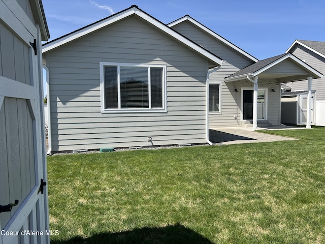9256 Gettys Ln, Hayden, ID 83835 - back of house featuring a patio, a storage shed, an outbuilding, and a yard