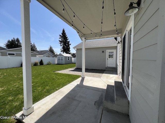 9256 Gettys Ln, Hayden, ID 83835 - view of patio with fence, an outbuilding, and a storage unit