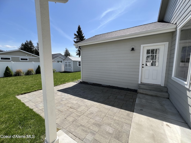 9256 Gettys Ln, Hayden, ID 83835 - view of patio / terrace featuring a storage unit, fence, and an outbuilding