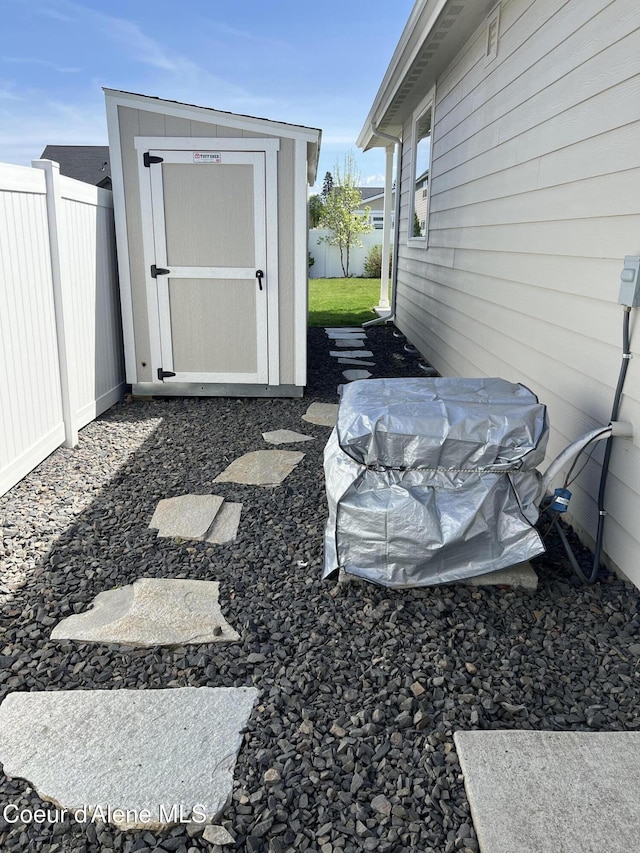 9256 Gettys Ln, Hayden, ID 83835 - view of yard with a storage unit, an outdoor structure, and fence