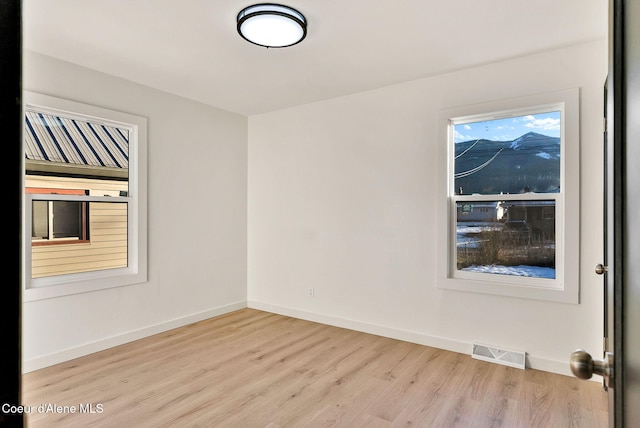 unfurnished room featuring light wood-type flooring