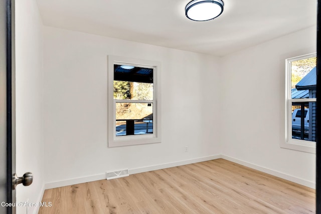 unfurnished room with light wood-type flooring