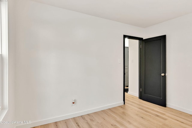 empty room with light hardwood / wood-style flooring