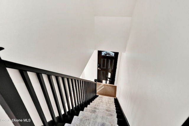 staircase with a towering ceiling