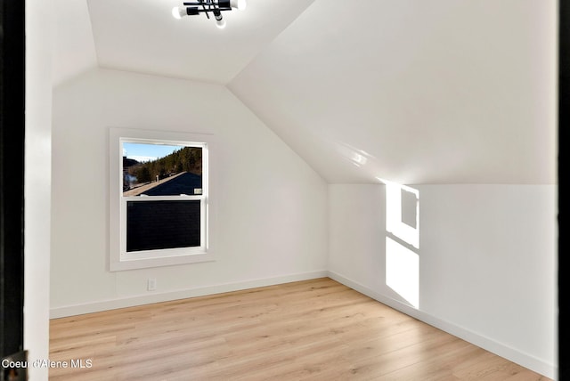 bonus room featuring vaulted ceiling and light wood-type flooring