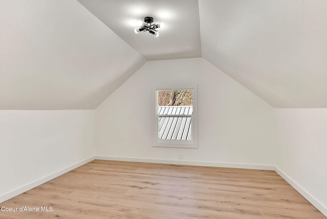 bonus room featuring vaulted ceiling and light hardwood / wood-style flooring