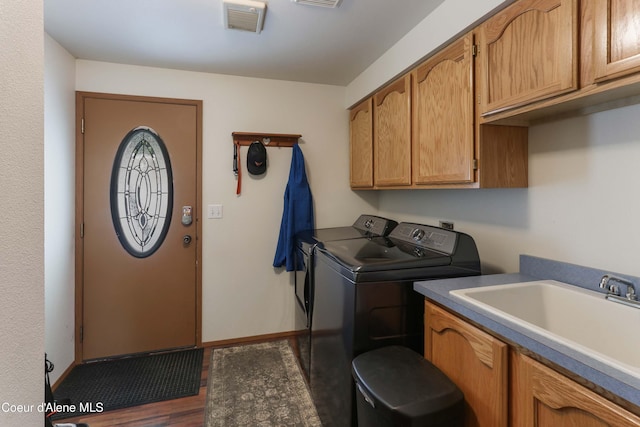 laundry room featuring cabinets, washer and dryer, and sink