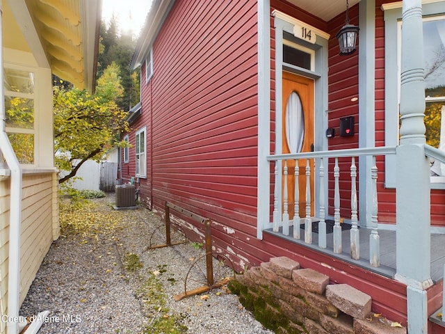 view of side of property featuring central AC unit and a porch