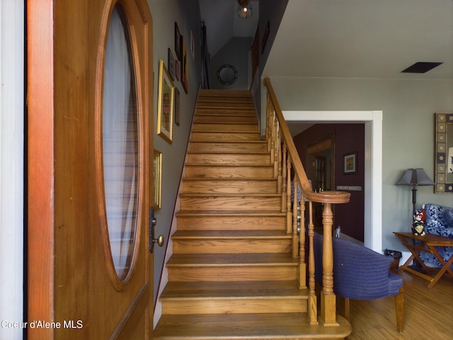 stairs with hardwood / wood-style floors