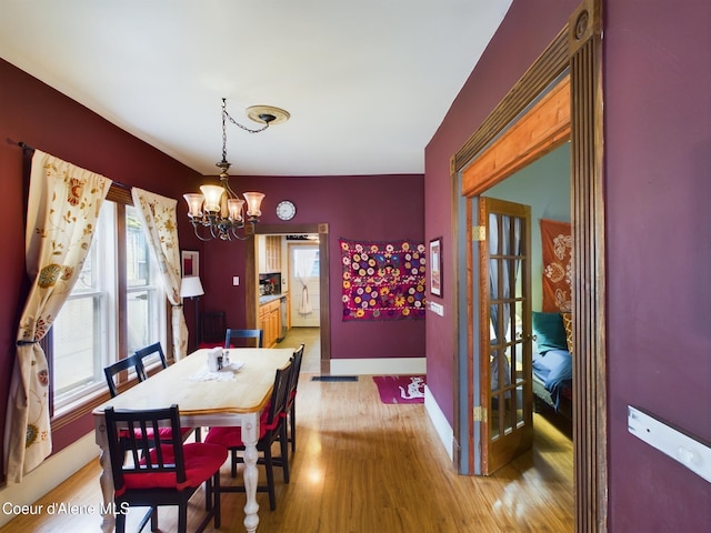 dining area featuring a chandelier and light wood-type flooring