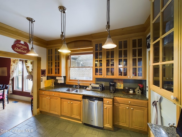 kitchen featuring hanging light fixtures, dishwasher, sink, and crown molding