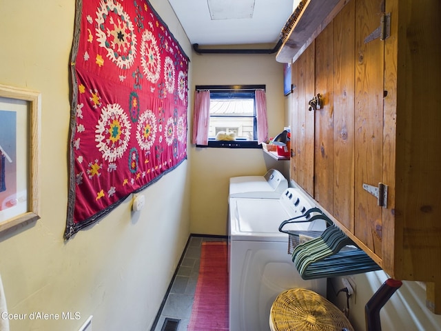 washroom featuring dark tile patterned flooring and washing machine and clothes dryer