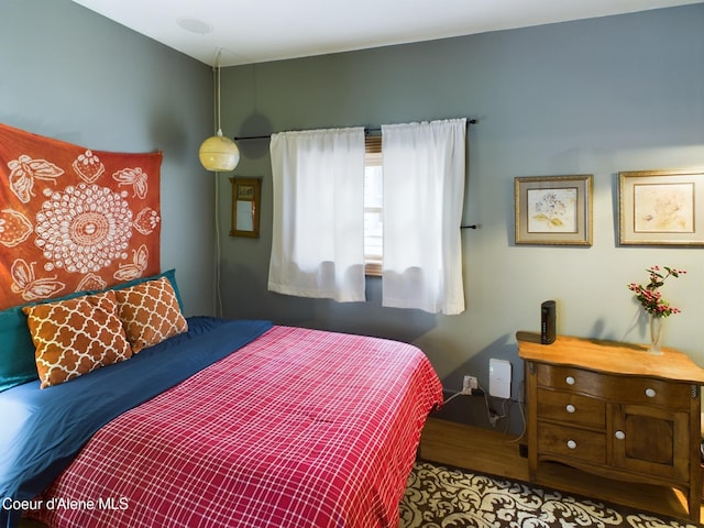 bedroom with wood-type flooring